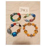 FOUR BRACELETS ON ELASTIC WITH LARGE GLASS BEADS