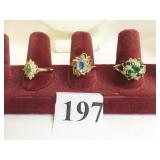THREE GOLD TONE RINGS SINGLE GREEN STONE WITH