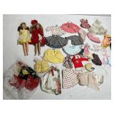 TWO BARBIES AND CLOTHING W/ CASE