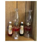2 OIL LAMPS WITH EXTRA BOTTLES OF OIL