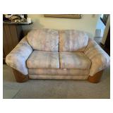 UPHOLSTERED LOVE SEAT WITH WOOD DETAIL