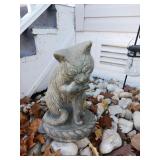 CEMENT CAT CLEANING ITS PAW