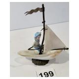 BISQUE FIGURE W/ SHELL BOAT AND SAIL W/ FLAG 4.5"