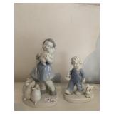 FIGURINE OF GIRL WITH PIGS AND TODDLER WITH TOYS