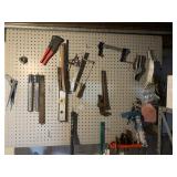 WALL OF TOOLS, LEVELS, PIPE WRENCH, CLAMP,