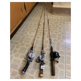 THREE FISHING RODS W/ REELS