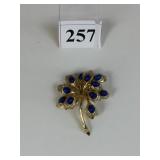 BOUCHER GOLD TONE FLOWER PIN WITH BLUE STONES