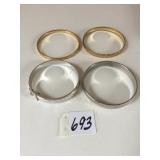 FOUR BANGLE BRACELETS TWO GOLD TONE TWO SILVER