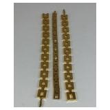 THREE GOLD TONE BRACELETS ONE WITH RHINESTONES