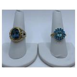 RINGS 10K W/ BLUE TOPAZ W/ DIAMOND CHIPS ON SIDE