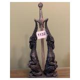 SWORD RESTING ON UNUSUAL STAND