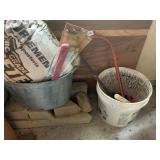 CONCRETE BAGS HALF FULL AND GARDEN TOOLS SAW