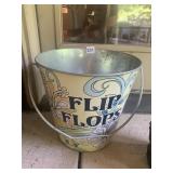 LARGE ALUMINUM BUCKET LABELED FLIP FLOPS