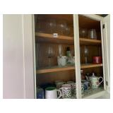 3 SHELVES IN KITCHEN OF TEA POTS AND GLASSES ETC.