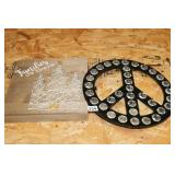 2 WALL PIECES. A BLACK AND SILVER PEACE SIGN AND
