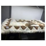 FUR RUG HAND STITCHED TOGETHER, SIGNED, 42 X 24