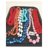 GROUP OF PLASTIC BEADED NECKLACES PINK RED WHITE