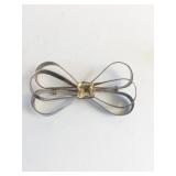 BOW PIN WITH THREE LOOPS CENTER YELLOWISH STONE
