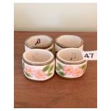 FOUR CERAMIC FLORAL NAPKIN HOLDERS