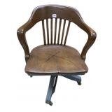MID-CENTURY CURVED-BACK CHAIR ON CASTERS SOLID