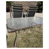 PATIO TABLE GLASS TOP AND 6 STACKING CHAIRS