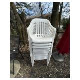 STACK OF PLASTIC OUTDOOR CHAIRS