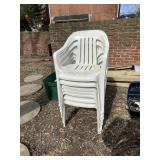 STACK OF PLASTIC OUTDOOR CHAIRS