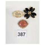 CARVED FRIEDA OVAL PIN BLACK FLOWER GOLD TONE PIN