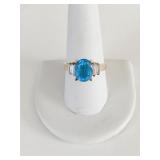 RING BLUE TOPAZ SET IN 18K GOLD W/ 4 CZ SIDE