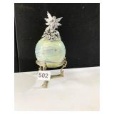 SIGNED GLASS BALL ON STAND WITH FAIRY ON TOP