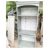 GREEN PAINTED CABINET WITH WALLPAPER BACK DROP