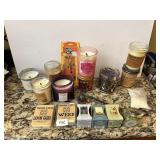 AN ASSORTMENT OF CANDLES SOME NEW, SOME BURNT,
