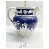 LARGE PITCHER WITH RAISED RELIEF PERSONS HAS