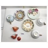 THREE TEACUPS & SAUCERS AND MINI ORANGE PITCHER &