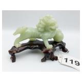 JADE LION ON CARVED WOOD STAND 4" X 2"