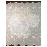 INTRICATE DOILIES IN SHADES OF WHITE AND IVORY,
