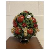 PLASTIC FRUIT AND HOLLY CENTERPIECE IN A HULL