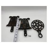 2 WILTON CAST IRON TRIVETS AND STAR CENTER TRIVET