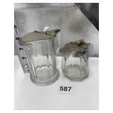 TWO VINTAGE GLASS SYRUP CONTAINERS WITH METAL