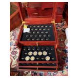 $1.00 GOLD TONE COINS IN GLASS TOP CASE