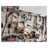 SECTION OF GARAGE WALL INCLUDING HEDGE TRIMMERS,