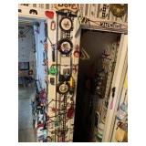 TRINKETS AND BUNGEES ON SKINNY WALL BETWEEN DOORS