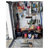 SECTION OF GARAGE WALL INCLUDING HAND SAWS, PICK