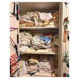 ASSORTED TOWELS AND ITEMS HANGING ON INSIDE OF