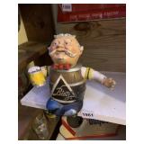 BLATZ BEER MAN W/ LEGS CROSSED HOLDING BEER MUG