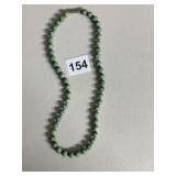 CARVED GREEN STONE BEADS WITH SILVERTONE SPACERS