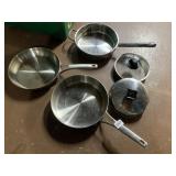 GROUP OF STAINLESS STEEL COOKWARE COMPRISING