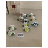 COLLECTION OF NINE CERAMIC FLORAL BROOCHES