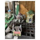 GROUP OF FOUR PAINTED RESIN MINIATURE COTTAGE