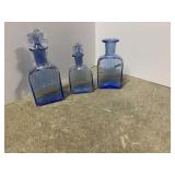 THREE COBALT BLUE GLASS VANITY BOTTLES WITH